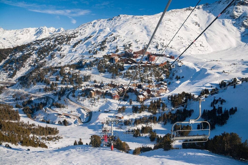 Purpose-built ski resort with apartment blocks and a chairlift in the foreground